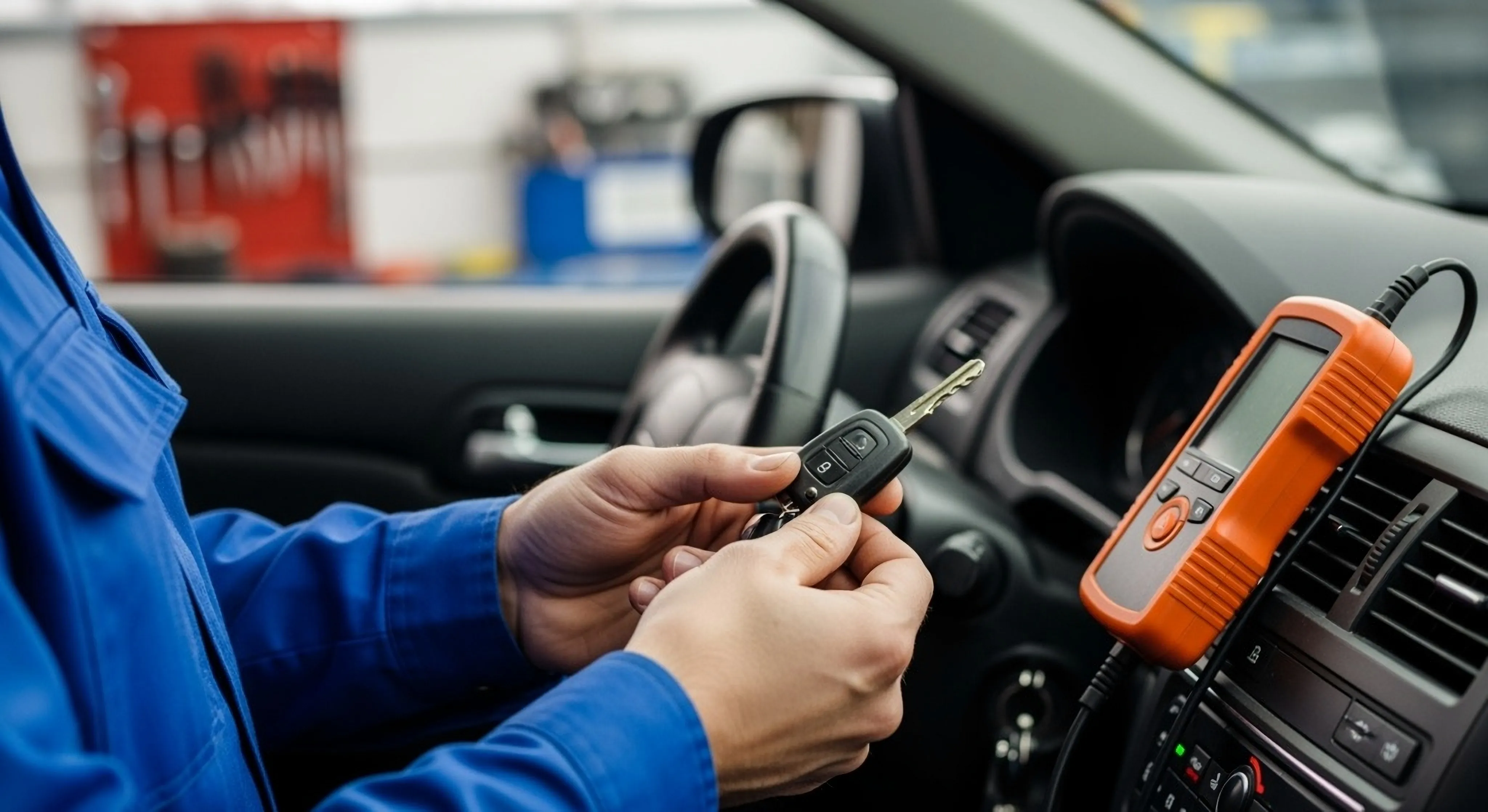 Locksmith working on a car key inside a vehicle