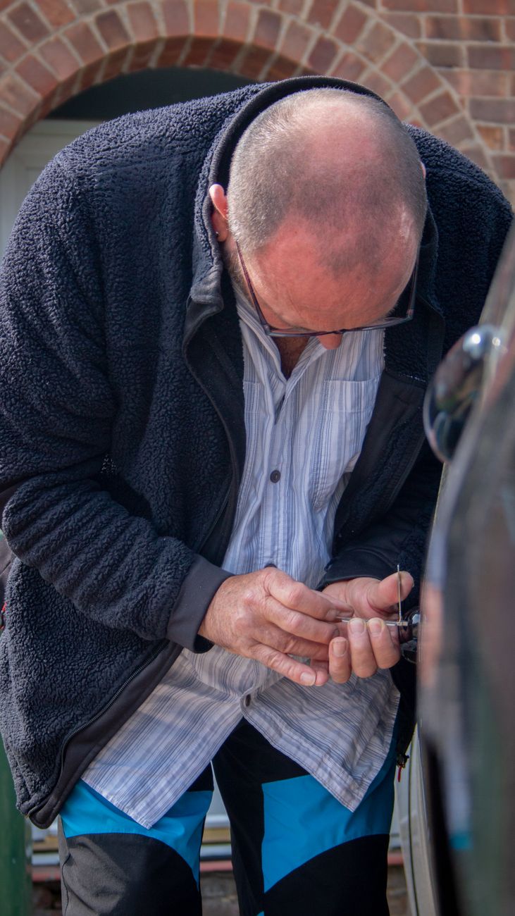 Locksmith handing over a car key fob to a customer
